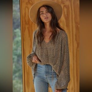 Oversized tie front billowy long sleeved spotted top lightweight and flowy